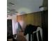 A dimly lit bedroom with wood paneling, a fan, and assorted items at 5324 Del Monte Ave, Las Vegas, NV 89146