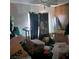 A cluttered bedroom with a dark curtain and various boxes strewn around the room at 5324 Del Monte Ave, Las Vegas, NV 89146