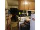 Cluttered kitchen with wood cabinets and white appliances at 5324 Del Monte Ave, Las Vegas, NV 89146