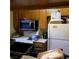 A basic kitchen featuring wood cabinets, a microwave, and a white refrigerator at 5324 Del Monte Ave, Las Vegas, NV 89146