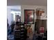 A cluttered living room with furniture, boxes, and a doorway to another room at 5324 Del Monte Ave, Las Vegas, NV 89146