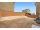 Large, empty backyard features a privacy wall, offering plenty of space for customization and outdoor living at 5340 Kennedy Hill Ave, Las Vegas, NV 89139