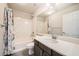 Bathroom featuring single sink vanity with marble countertop and shower-tub combination at 5340 Kennedy Hill Ave, Las Vegas, NV 89139