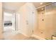 This bathroom offers a clear glass shower, tile flooring, and entry to the main bedroom at 5340 Kennedy Hill Ave, Las Vegas, NV 89139