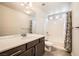Modern bathroom with a marble countertop, updated fixtures, and a shower-tub combination with a stylish shower curtain at 5340 Kennedy Hill Ave, Las Vegas, NV 89139