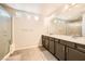 Bright bathroom featuring a double sink vanity and a glass-enclosed shower at 5340 Kennedy Hill Ave, Las Vegas, NV 89139
