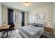 Staged bedroom with modern decor, work space, and neutral colors at 5340 Kennedy Hill Ave, Las Vegas, NV 89139