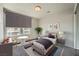 Cozy staged bedroom with a large window, stylish rug, and modern decor at 5340 Kennedy Hill Ave, Las Vegas, NV 89139