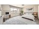 Bright bedroom featuring a modern workspace, large windows, and a cozy bed with neutral decor at 5340 Kennedy Hill Ave, Las Vegas, NV 89139