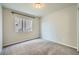 Empty bedroom features carpet, a ceiling light, and a side window at 5340 Kennedy Hill Ave, Las Vegas, NV 89139