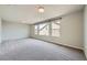 Bright bonus room featuring large windows offering neighborhood views and plush carpet at 5340 Kennedy Hill Ave, Las Vegas, NV 89139