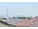 This daytime shot shows a distant city view behind rooftops and powerlines at 5340 Kennedy Hill Ave, Las Vegas, NV 89139