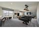 Spacious game room featuring a pool table, poker table, and a comfortable seating area at 5340 Kennedy Hill Ave, Las Vegas, NV 89139