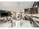 This kitchen overlooks the dining and living areas and has stainless appliances, dark wood cabinets, and a granite island at 5340 Kennedy Hill Ave, Las Vegas, NV 89139