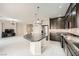 This kitchen overlooks the living areas and has stainless appliances, dark wood cabinets, and a granite island at 5340 Kennedy Hill Ave, Las Vegas, NV 89139