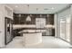 Modern kitchen features dark cabinets, an island with granite countertop, and stainless steel appliances at 5340 Kennedy Hill Ave, Las Vegas, NV 89139