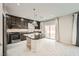 Modern kitchen features dark cabinets, an island with a granite countertop, and stainless steel appliances at 5340 Kennedy Hill Ave, Las Vegas, NV 89139