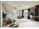 This staged living room includes seating, a work area, and decor accents that showcase its open concept design at 5340 Kennedy Hill Ave, Las Vegas, NV 89139