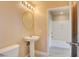 Bright bathroom includes a pedestal sink, toilet, and an open view into a bathtub and shower at 55 E Agate Ave # 309, Las Vegas, NV 89123
