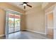 Bright bedroom featuring a ceiling fan, gray flooring, and sliding glass door leading to a balcony at 55 E Agate Ave # 309, Las Vegas, NV 89123