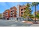 Condominium building exterior with garage parking, trees, and balconies, offering a charming urban living experience at 55 E Agate Ave # 309, Las Vegas, NV 89123