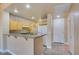 Well-lit kitchen with light wood cabinets, granite countertops, breakfast bar and modern appliances providing ample space at 55 E Agate Ave # 309, Las Vegas, NV 89123