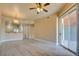 Bright living room featuring modern flooring, ceiling fan and sliding glass door to balcony, offering a serene living space at 55 E Agate Ave # 309, Las Vegas, NV 89123