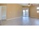 Spacious living room with a sliding glass door leading to balcony, neutral color palette, and modern flooring at 55 E Agate Ave # 309, Las Vegas, NV 89123