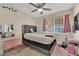 Cozy bedroom with natural light, personal decor, and hardwood floors at 5530 Berchmans Ave, Las Vegas, NV 89122