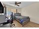 Bedroom featuring hardwood floors, ceiling fan, and a large window at 5530 Berchmans Ave, Las Vegas, NV 89122