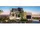 Modern two-story home boasts contemporary design with sleek lines and a well-manicured desert landscape at 557 Overlook Rim Dr, Henderson, NV 89012