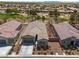 Aerial view of a residential property with desert landscaping and a tile roof at 5635 E La Campana Dr, Pahrump, NV 89061