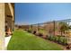 Beautiful landscaping, turf grass, and inviting outdoor space in the backyard at 5635 E La Campana Dr, Pahrump, NV 89061