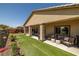 Inviting backyard with a covered patio, outdoor seating, and lush artificial turf at 5635 E La Campana Dr, Pahrump, NV 89061