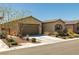 Attractive single-story home with a well-maintained lawn, desert landscaping, and a two-car garage at 5635 E La Campana Dr, Pahrump, NV 89061