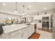 Modern kitchen with island, stainless appliances, and an open layout to the dining area at 5635 E La Campana Dr, Pahrump, NV 89061