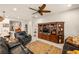 Cozy living room features a ceiling fan, a wooden media center, and hardwood-style flooring at 5635 E La Campana Dr, Pahrump, NV 89061
