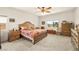 Spacious main bedroom with neutral carpet, ceiling fan, and a window with views to the backyard at 5635 E La Campana Dr, Pahrump, NV 89061