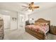 Comfortable main bedroom with neutral carpet, ceiling fan, and access to an en suite bathroom at 5635 E La Campana Dr, Pahrump, NV 89061
