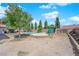 A kidney-shaped pool features mature trees and landscaping at 6150 W Brooks Ave, Las Vegas, NV 89108
