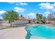 The backyard includes a kidney-shaped pool, and lush, mature landscaping at 6150 W Brooks Ave, Las Vegas, NV 89108