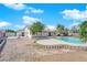 A kidney-shaped pool sits in a backyard with a home in the background at 6150 W Brooks Ave, Las Vegas, NV 89108