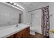 Bright bathroom featuring a single sink vanity, toilet and shower-tub combination at 6150 W Brooks Ave, Las Vegas, NV 89108