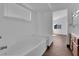 Primary bathroom featuring a bathtub with a window providing natural light at 6150 W Brooks Ave, Las Vegas, NV 89108