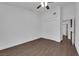 View of a simple bedroom featuring wood-look floors, ceiling fan and closet at 6150 W Brooks Ave, Las Vegas, NV 89108