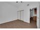 A bedroom with wood-look floors, ceiling fan, closet and access to bathroom at 6150 W Brooks Ave, Las Vegas, NV 89108