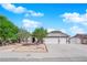 Charming single-story home featuring a three car garage, desert landscaping and a tile roof at 6150 W Brooks Ave, Las Vegas, NV 89108