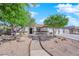 Charming single-story home featuring a three car garage, desert landscaping and a tile roof at 6150 W Brooks Ave, Las Vegas, NV 89108