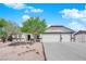 Charming single-story home featuring a three car garage, desert landscaping and a tile roof at 6150 W Brooks Ave, Las Vegas, NV 89108