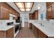 Spacious kitchen showcasing tile countertops, stainless-steel appliances, and wood-style flooring at 6150 W Brooks Ave, Las Vegas, NV 89108